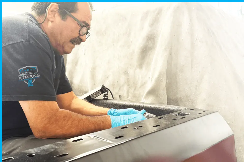 Athans technician preparing a body panel in the shop