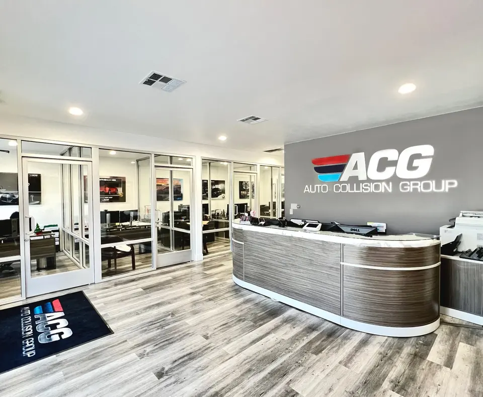 Reception desk and glass-walled offices in the Auto Collision Group Whittier lobby
