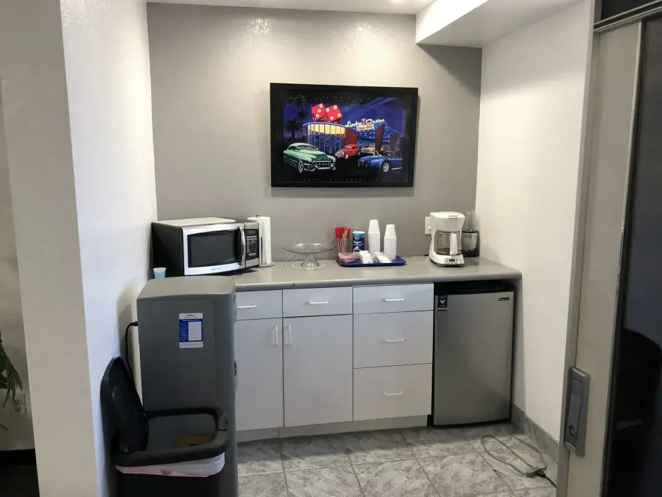 Customer break area with microwave, coffee maker and wall-mounted TV
