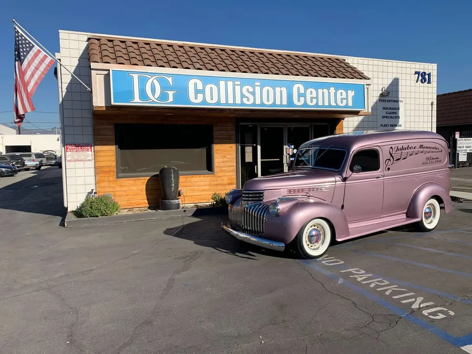 Front of the DG Collision Center building with its blue sign