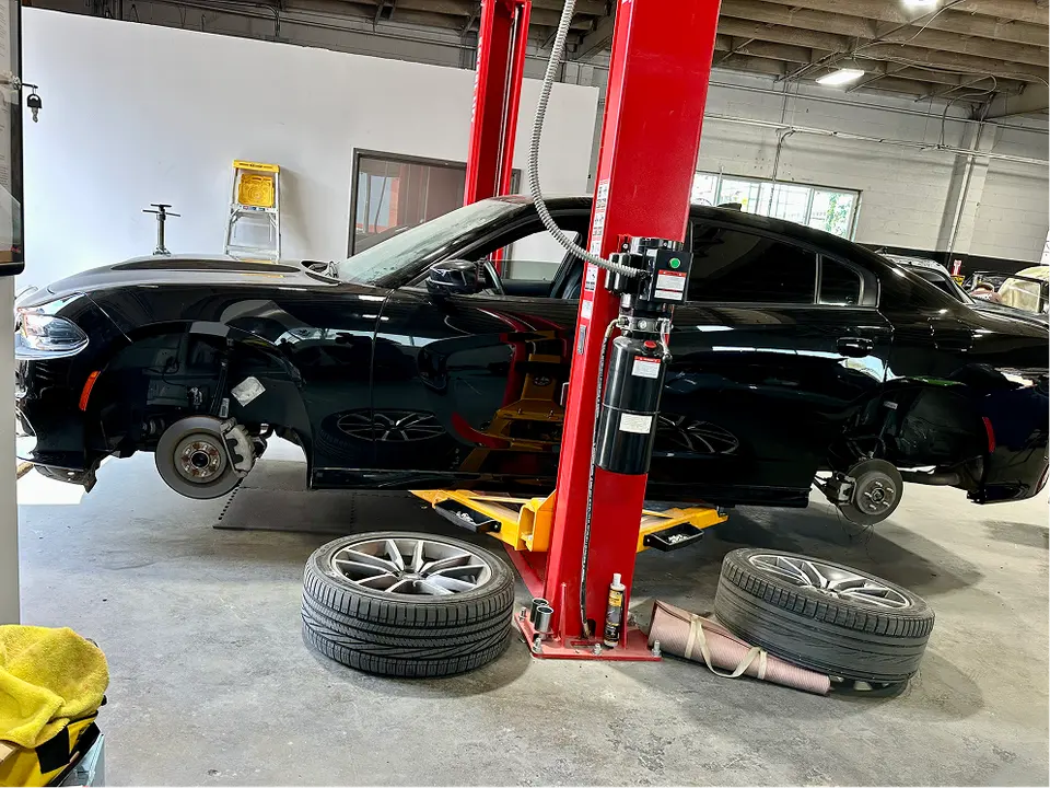 Car on a lift inside the Easy Fix Auto Body shop