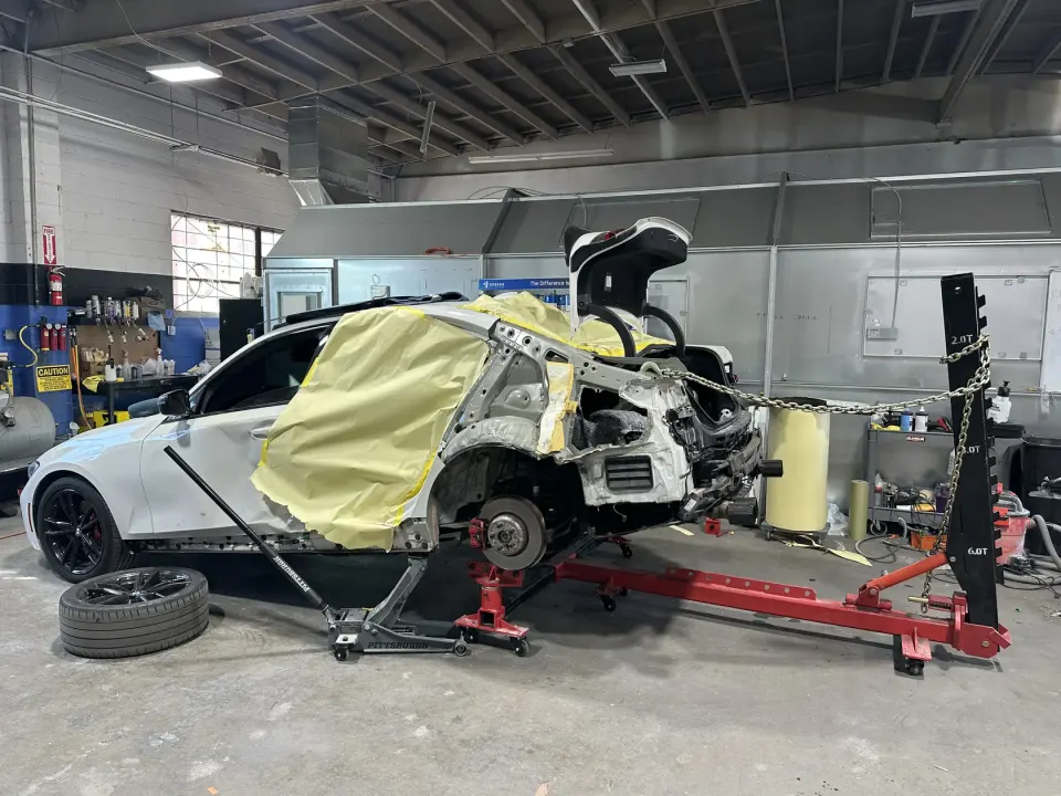 Vehicle on the frame bench in the Easy Fix Auto Body shop