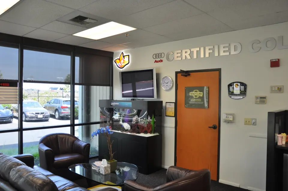 Customer lounge with leather seating and certified collision wall signage