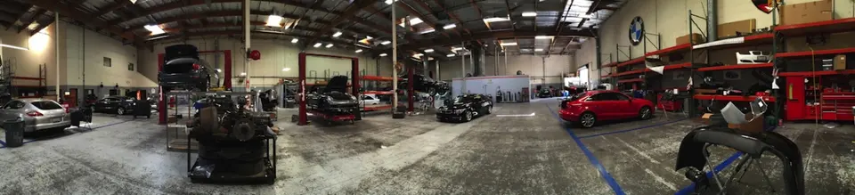 Panoramic view of the repair floor with vehicles on lifts