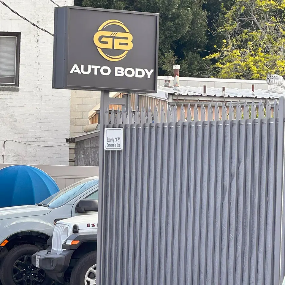 GB Auto Body sign and gate on Alger St