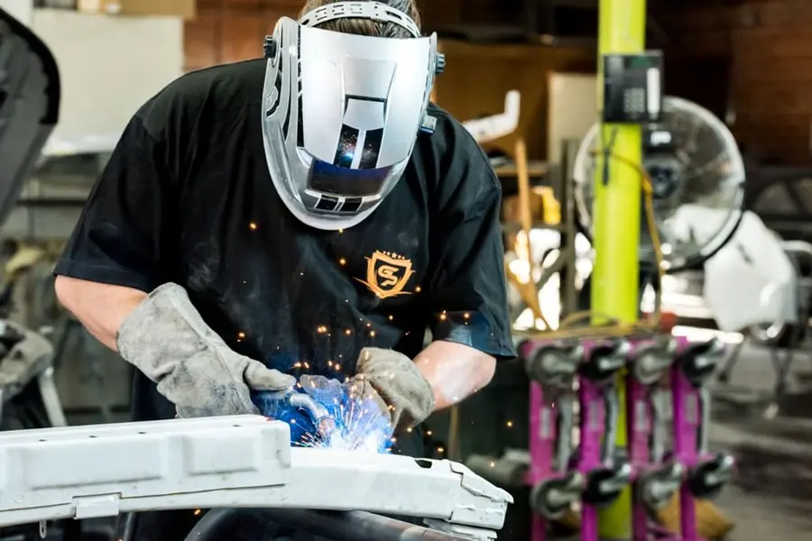 Grand Prix Auto Body technician welding in the shop