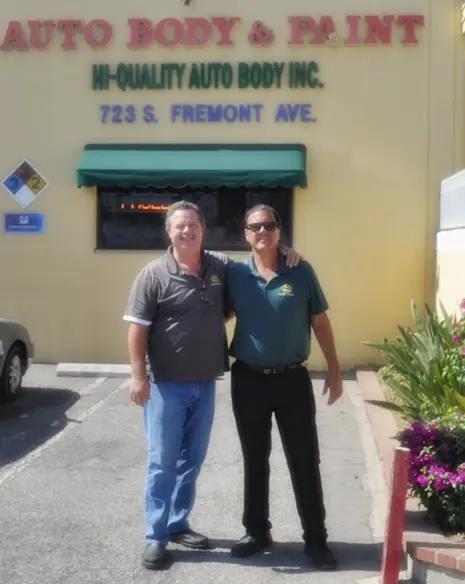 Owners of Hi-Quality Auto Body in front of the Fremont Ave shop