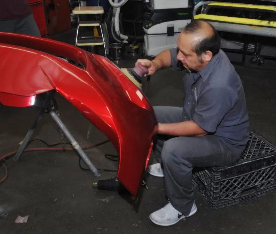 Technician working on a bumper at Hi-Quality Auto Body