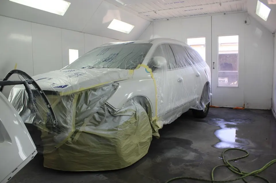 Vehicle prepped for refinishing inside the LA Collision Center spray booth