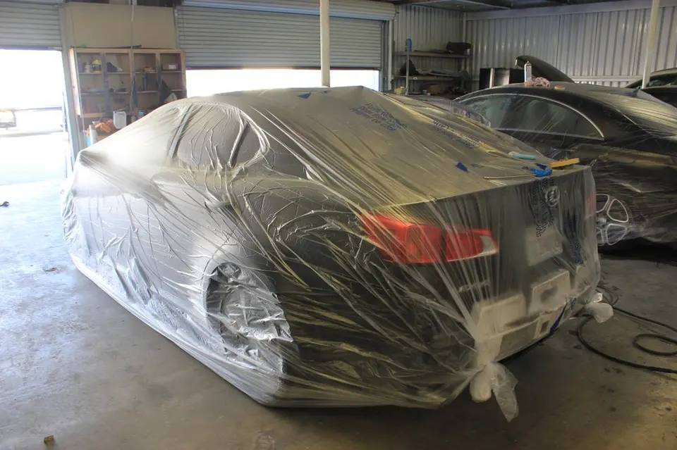 Repair bay at LA Collision Center with a vehicle wrapped for painting