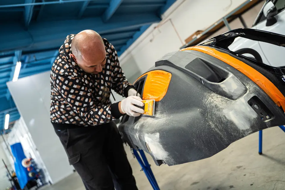 Technician prepping a bumper at Liontari