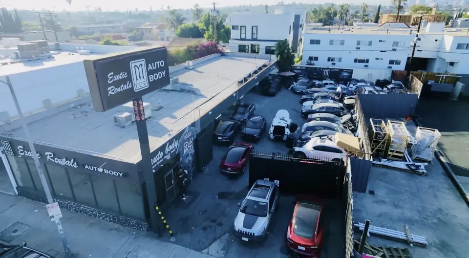 Aerial view of MLUX Auto Body and its lot on La Cienega Blvd