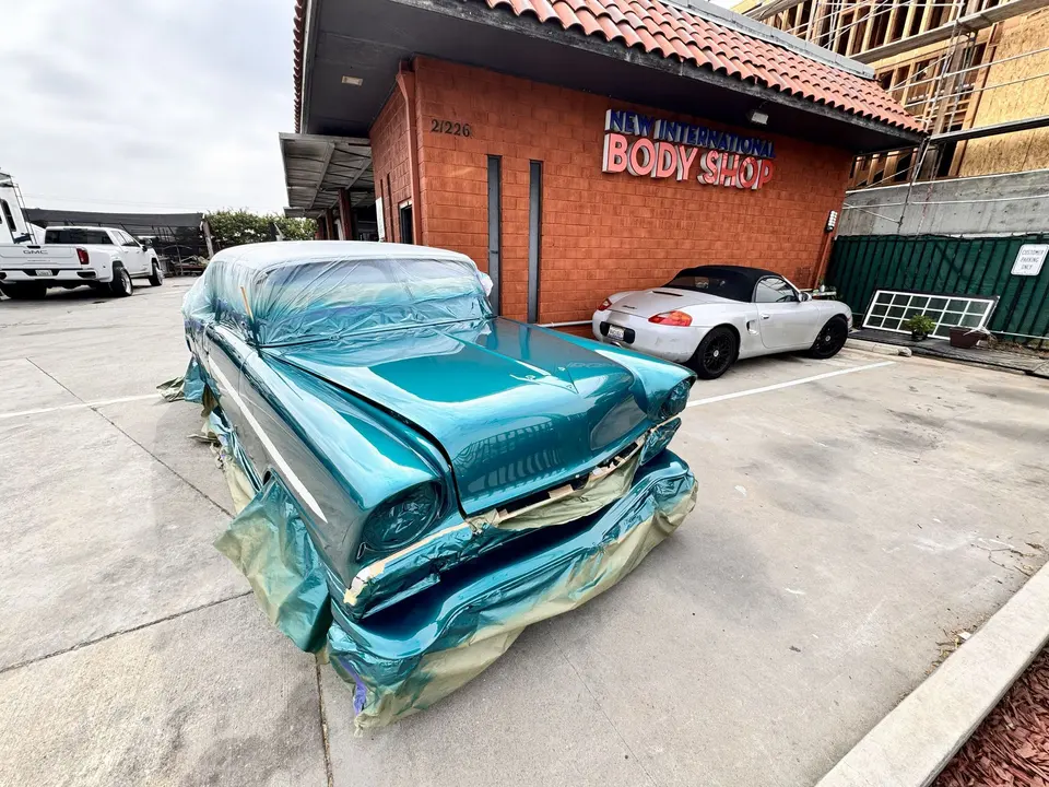 New International Auto Body Shop building and sign