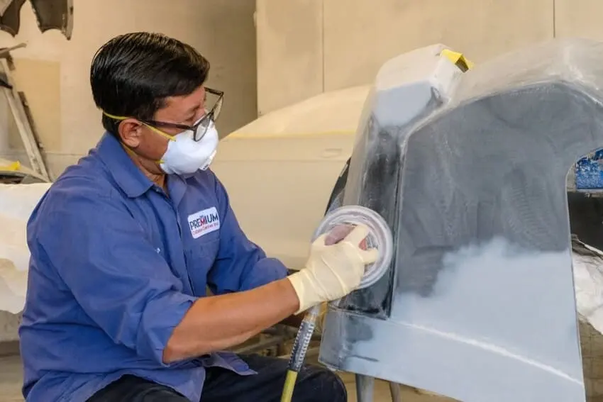 Technician sanding a panel in preparation for paint