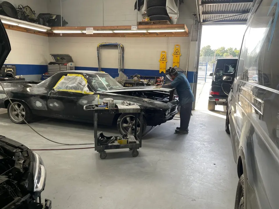 Vehicle on a frame rack in the Streamline Collision body shop