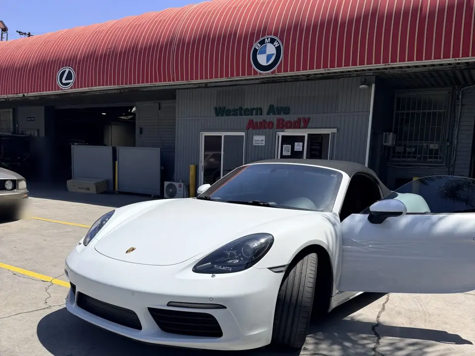 Entrance of Western Ave Auto Body under the red awning on Western Ave