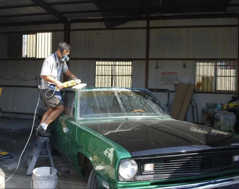 Classic car in primer in a Yosemite Auto Body work bay
